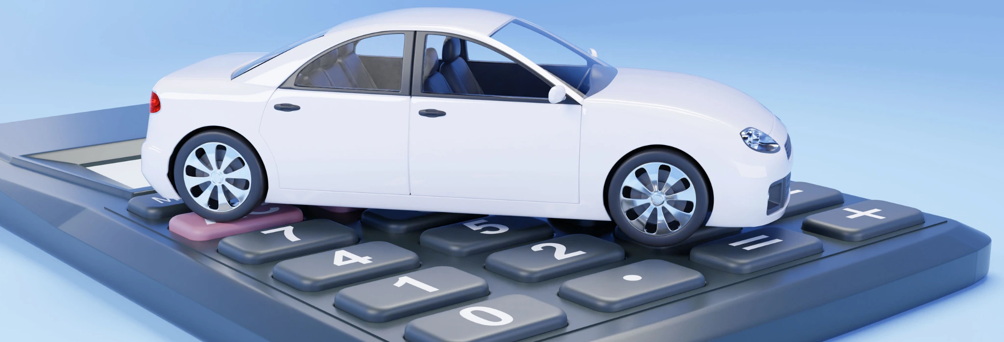 Λευκό αυτοκινητάκι μινιατούρα πάνω σε κομπιουτεράκι.