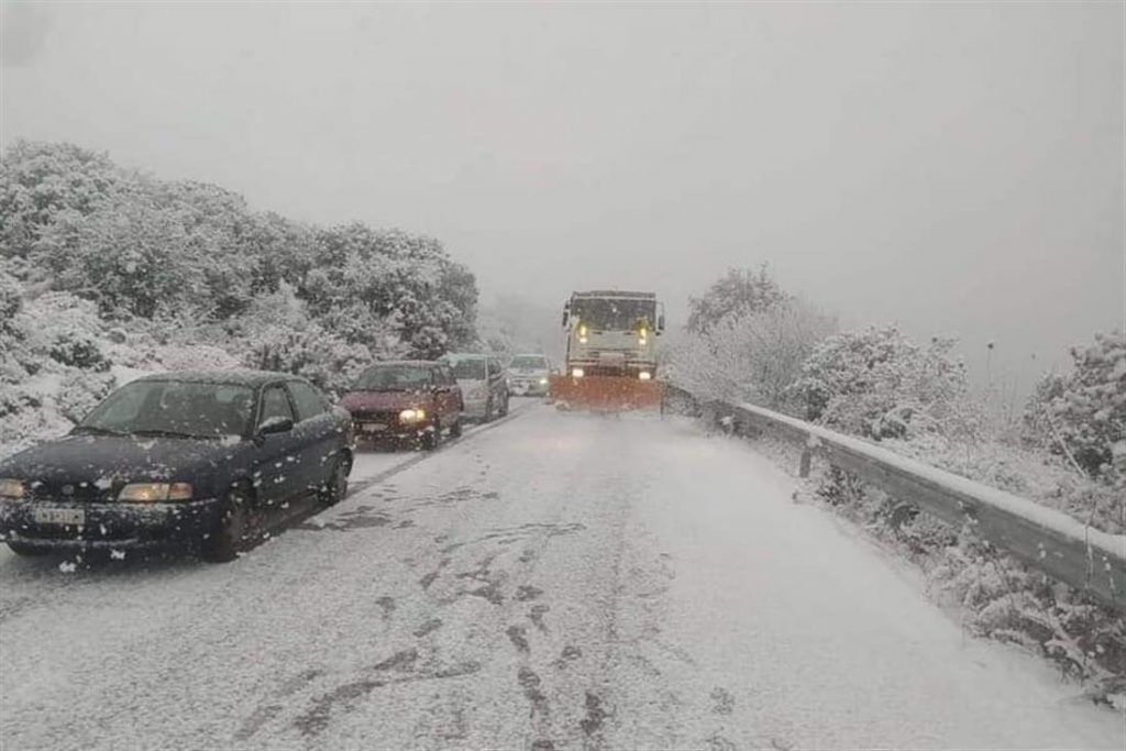 Χιονισμένος δρόμος με αυτοκίνητα.